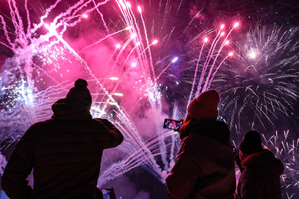 Люди снимают салют.